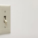 Dwell Time Minimization for Switched Delay Systems